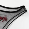 Close-up of black sheer mesh and red Hotwife embroidery