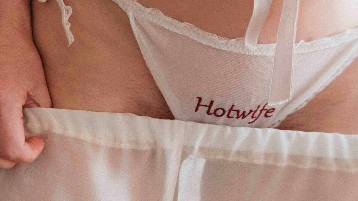 Horizontal preview crop of transparent white mesh Hotwife panties with custom red embroidery