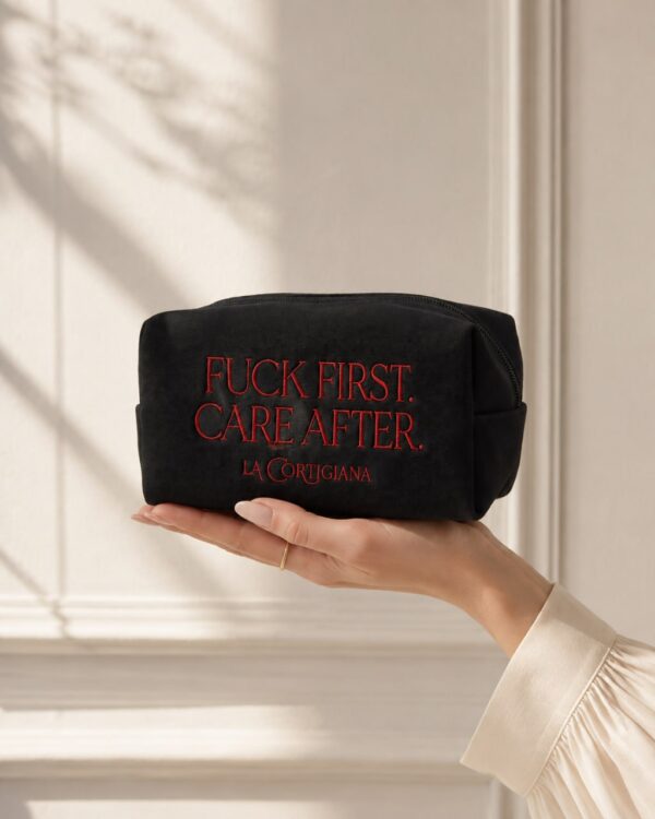 Fuck First Care After embroidered La Cortigiana pouch held in hand